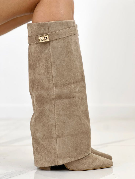 Beige suede knee-high boot with a gold buckle on a white background